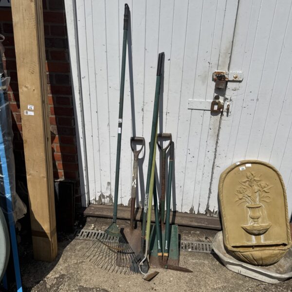 Vintage garden tool bundle with spade, fork, and rake.