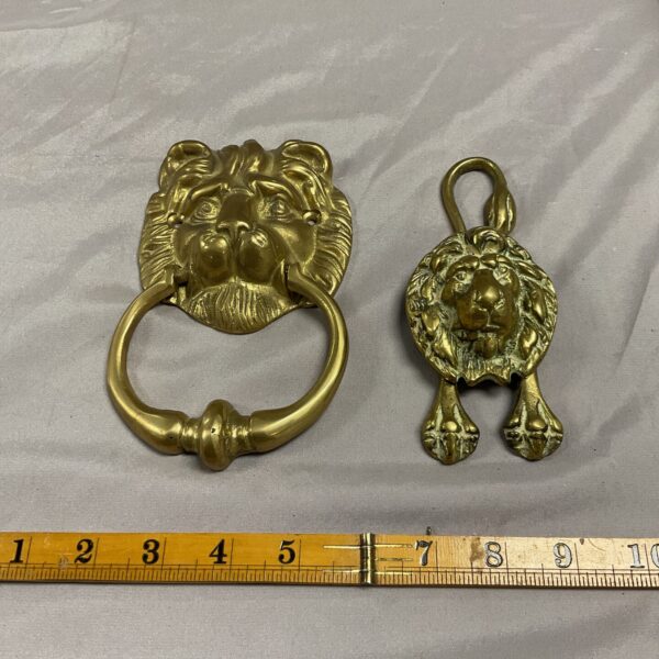 Detailed antique brass lion door knocker with classic design.