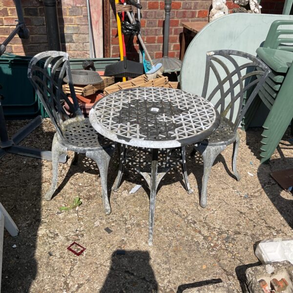 Vintage wrought iron garden set with geometric detailing.