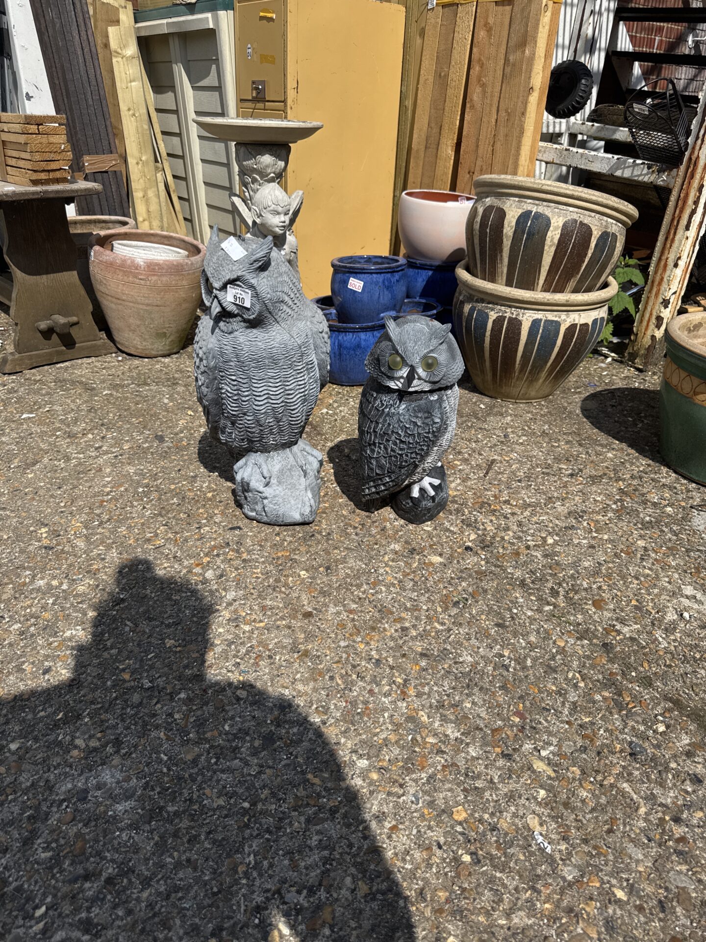 910 Two weighted plastic owl garden ornaments