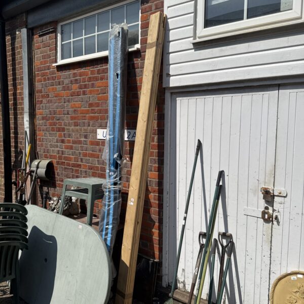 Bundle of timber lengths in a garden setting.