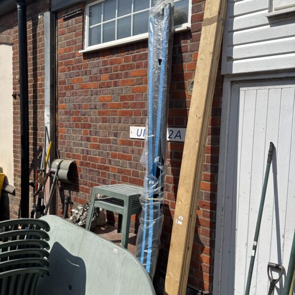 Black plastic cable trunking bundle in a garden setting.