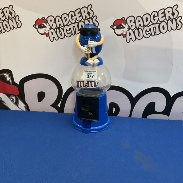 Front view of a vintage m&m gumball machine.