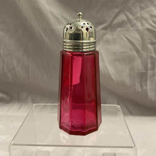 Antique cranberry glass sugar sifter with silver top.