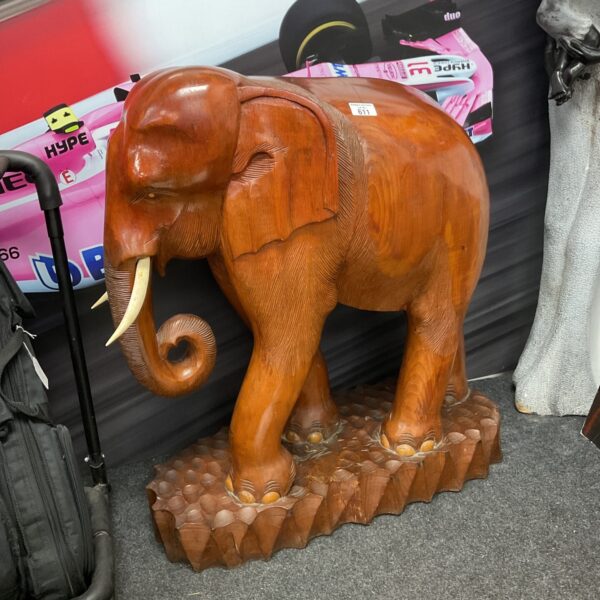 Large, hand-carved wooden elephant sculpture for home decor.