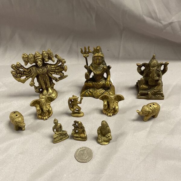 Collection of miniature Indian brass deities and Hindu god statues.