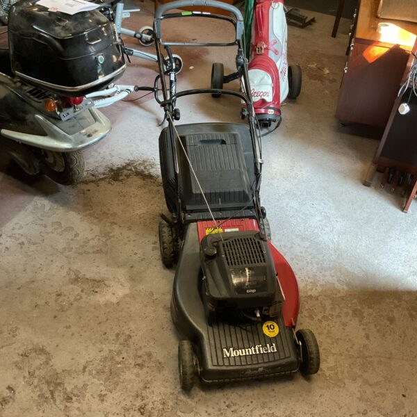 Used Mountfield Sp550 petrol mower in a garden setting.