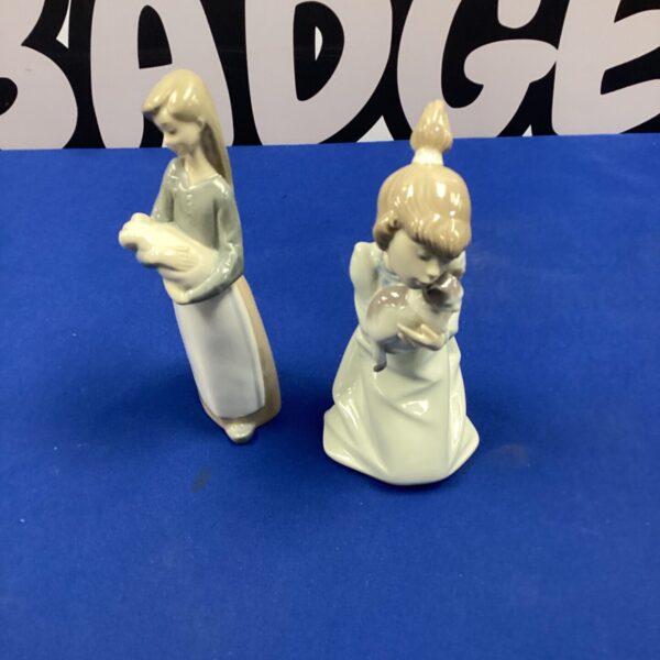 Vintage Lladro porcelain figurines of a girl with a cat and a pig.
