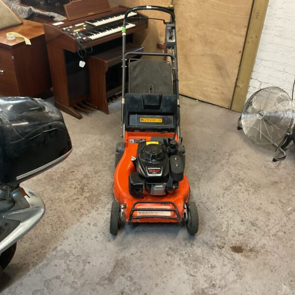 Used Honda GX160 petrol lawn mower in a garden setting.