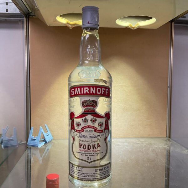 Red label Smirnoff vodka bottle, collectible spirits.