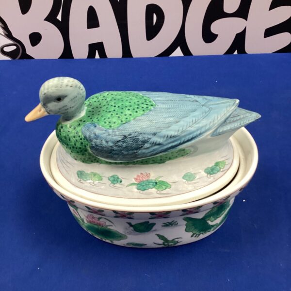 Vintage ceramic duck casserole dish with floral pattern.