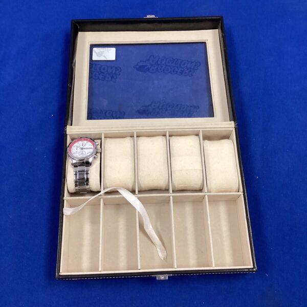 Vintage wooden watch box with a single timepiece inside.