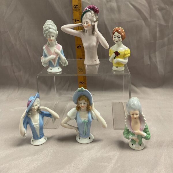 Group of six vintage German porcelain pincushion dolls.