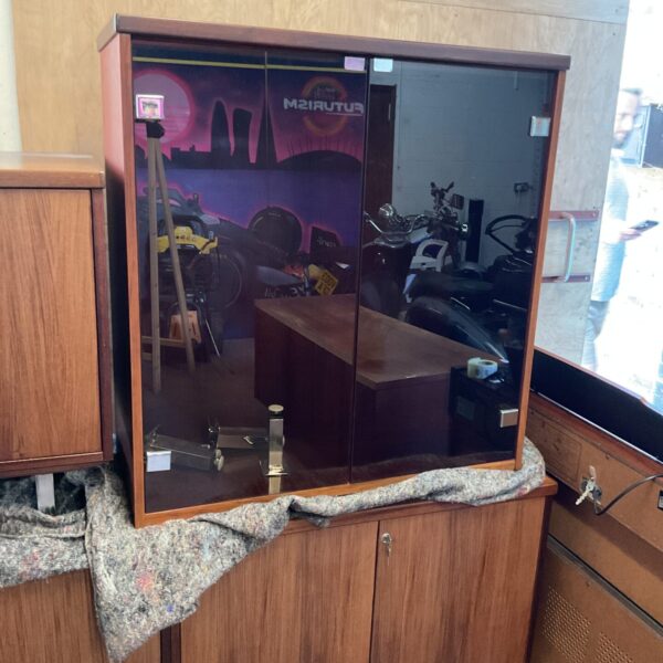Vintage mahogany display cabinet with glass door, ideal for collectibles.