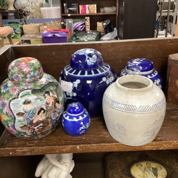 Collection of five colourful oriental ginger jars on display.