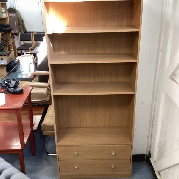 Beech effect bookshelf with multiple shelves and cupboard base.