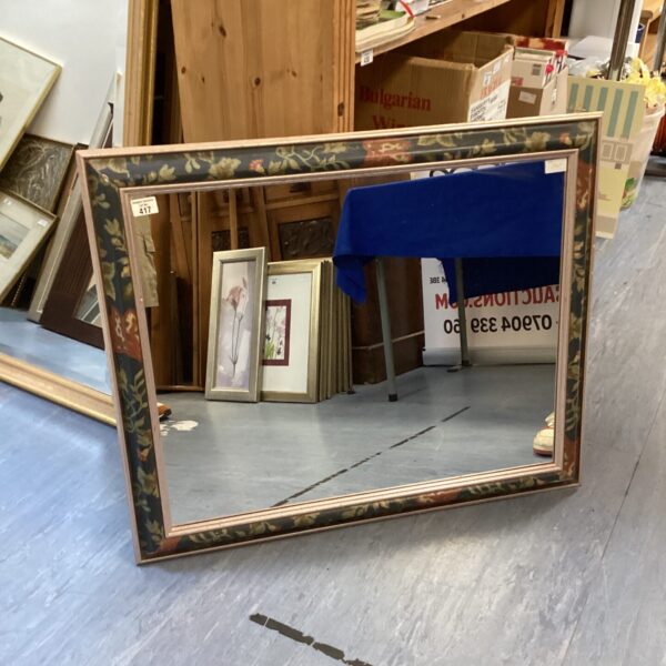 Large floral framed mirror with vintage detailing.
