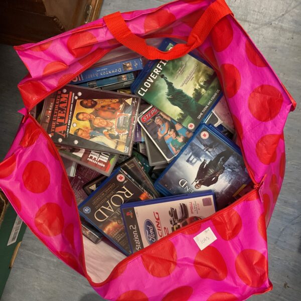 Large bundle of DVDs, CDs, and games for home entertainment.