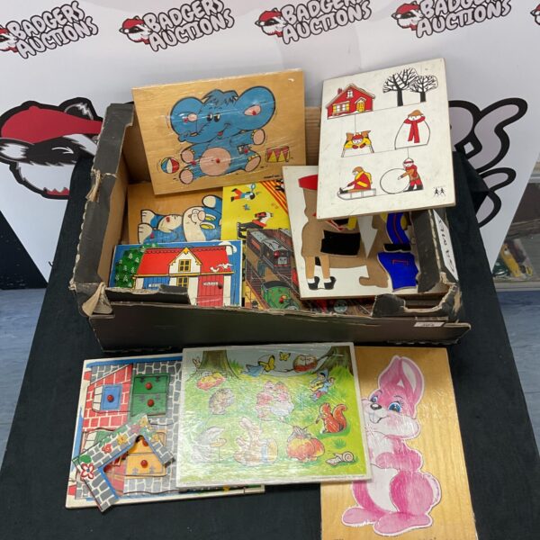 Tray of vintage wood jigsaw puzzles for children, collectible toys.