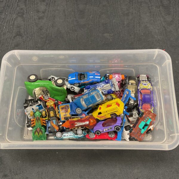 A box of assorted diecast cars including Hot Wheels and Tonka.