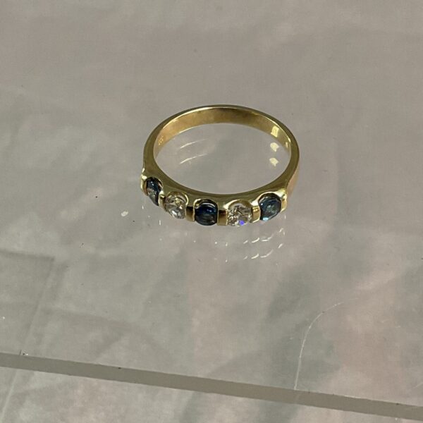 Vintage silver gilt half eternity ring with blue and white stones.