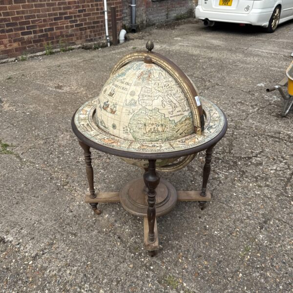 Vintage globe drinks cabinet with detailed world map.
