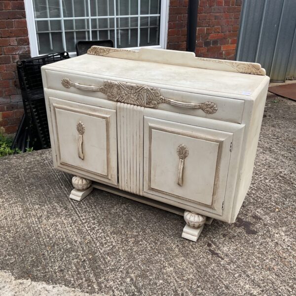 Front view of antique French carved oak sideboard with detailed carvings.