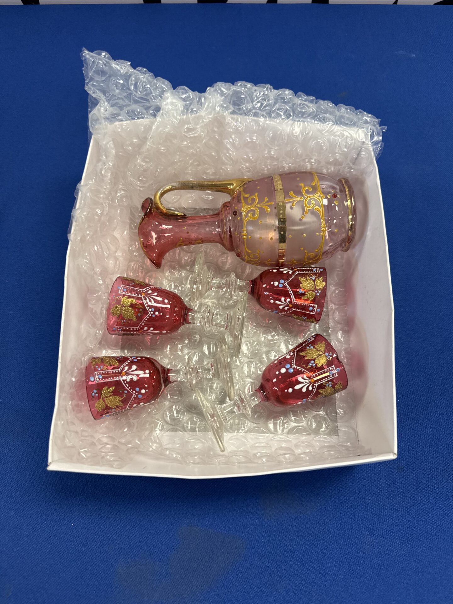 052 Vintage bohemian cranberry glass spirits serving jug with glasses (one glass has small chip on lip area)