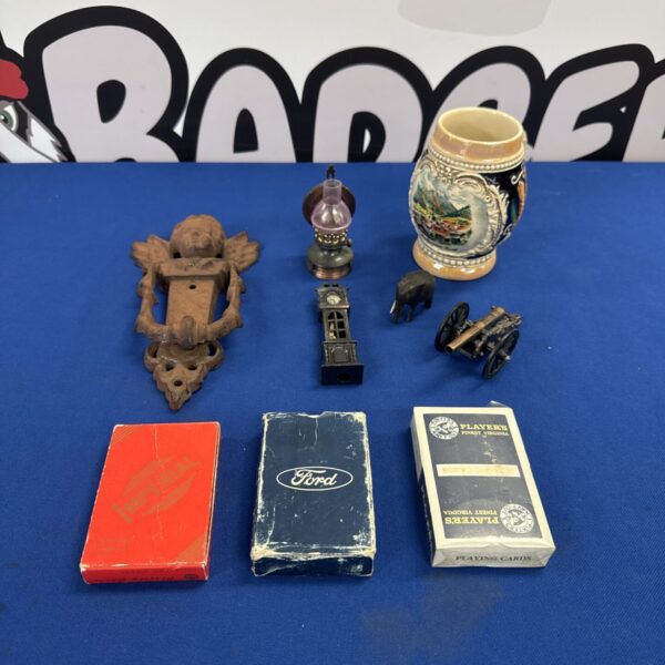 Vintage curios lot featuring a door knocker and playing cards.