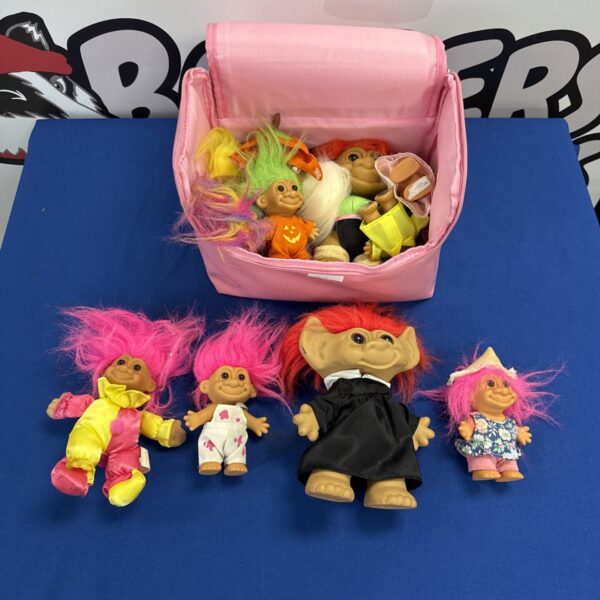 Vintage troll dolls in a pink carry bag, 90s collectible toys.
