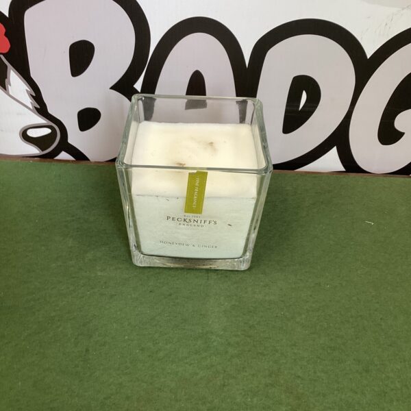 Pecksniffs honeydew and ginger scented candle in glass container.