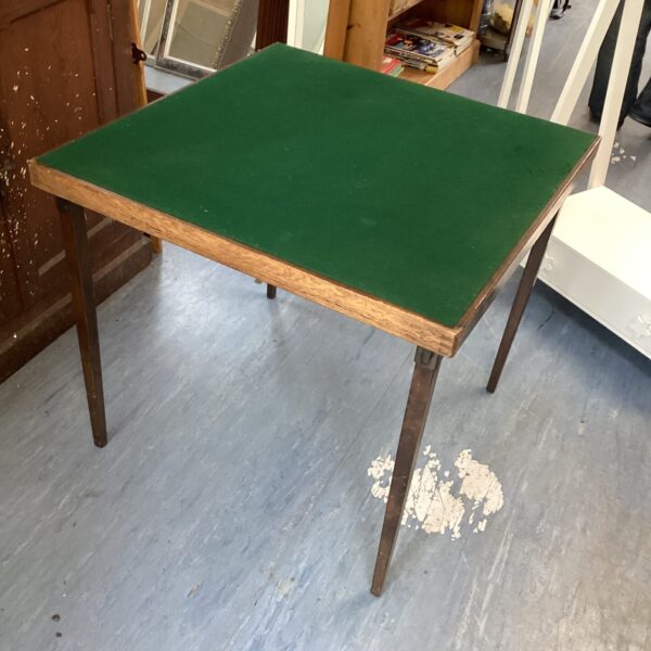 Vintage green felt folding card table for game nights.
