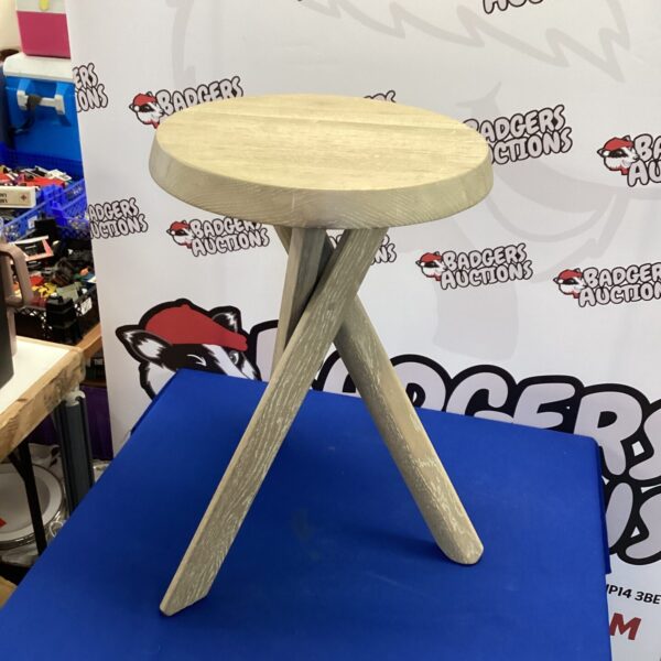 Light oak side table with three legs, ideal for bedside or end table use.