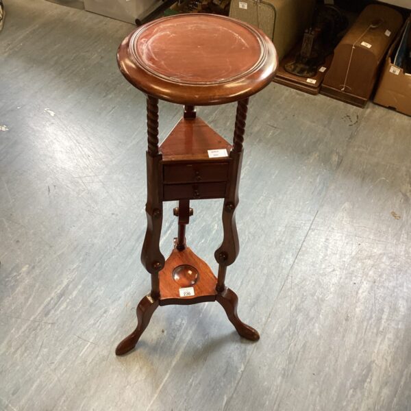 Antique mahogany wash basin stand with circular top and curved legs.