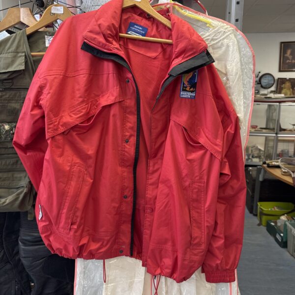 Vibrant red Results Stormdri Northern Lights rain coat for outdoor wear.