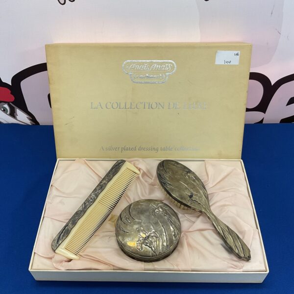 Vintage Anais Anais silver plate dressing table set with floral details.