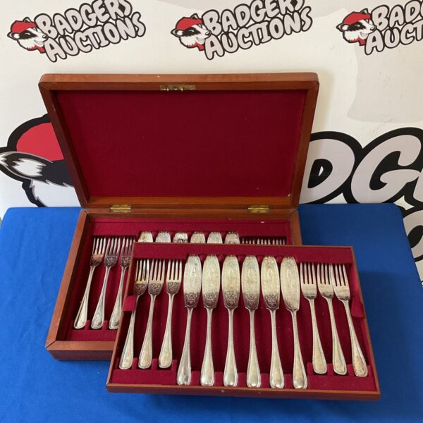 Vintage Walker & Hall silver plate fish cutlery set displayed.