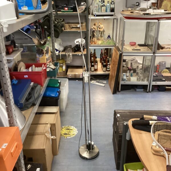 Modern uplighter floor lamp with adjustable reading light in a room.