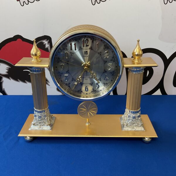 Ornate Great Japan quartz mantle clock with gold accents.