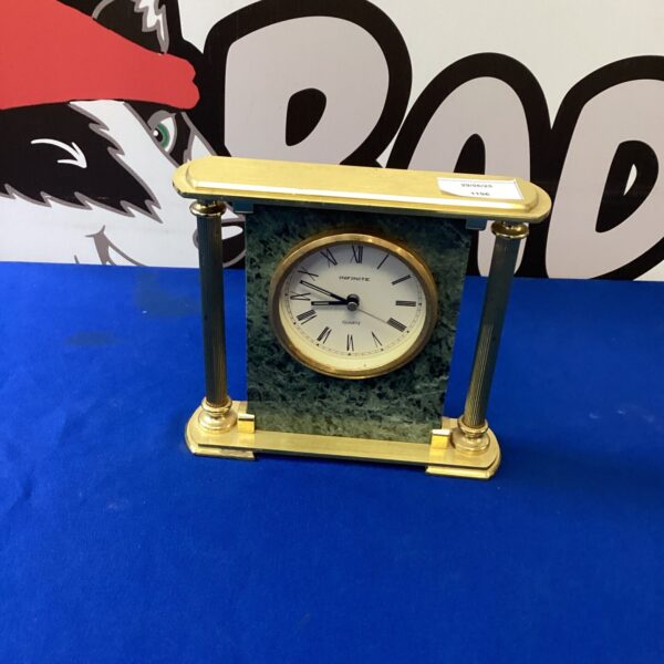 Vintage Infinite Quartz mantle clock with green casing.