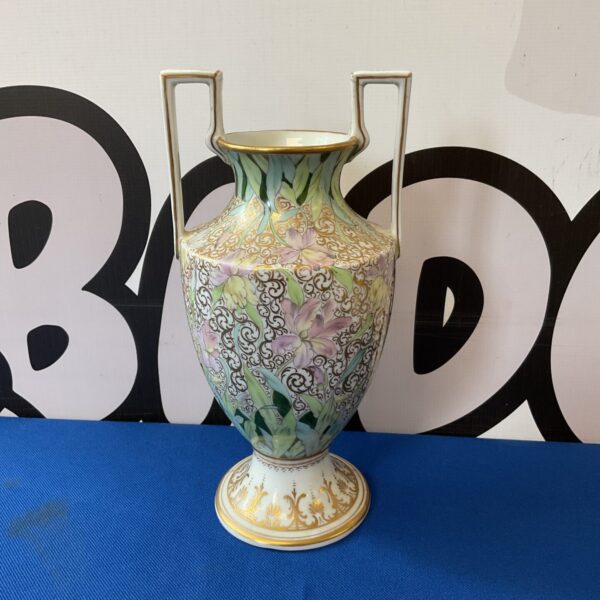Antique Dresden porcelain vase with delicate floral pattern and gilded handles.