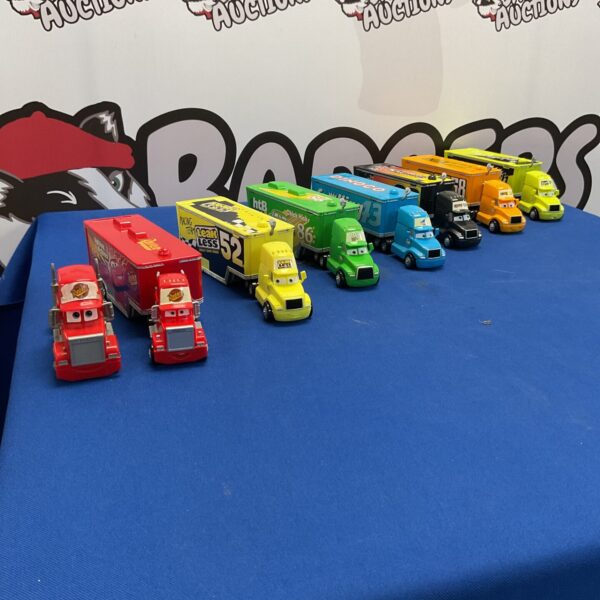 Group of Disney Pixar *Cars* diecast vehicles on a blue surface.
