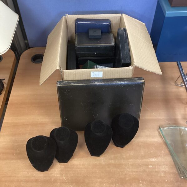 Collection of vintage jewellery boxes and stands for display.