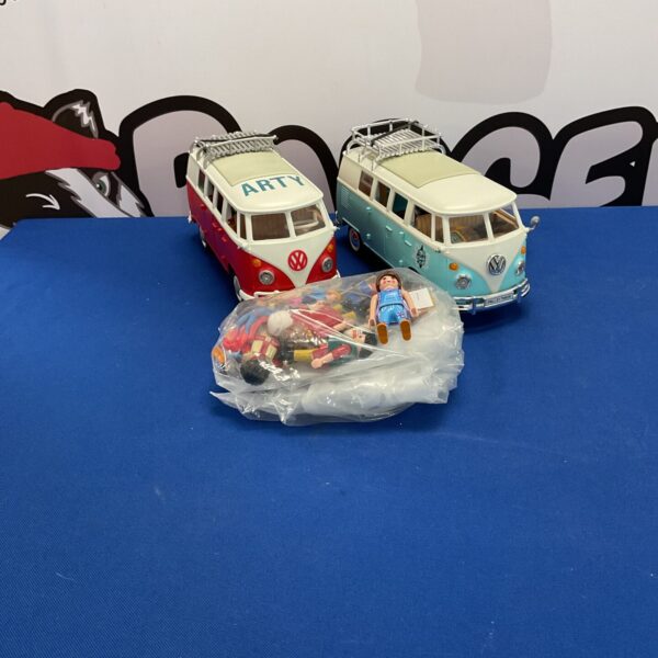 Vintage Playmobile campervan lot with figures, colourful toy vehicles.