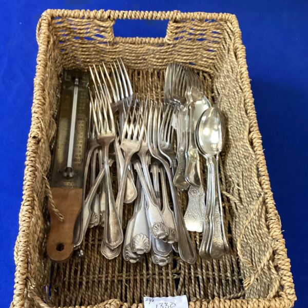 Vintage silverplate cutlery set with ornate designs.