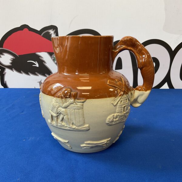 Antique Doulton Lambeth stoneware jug with a detailed hunt scene.