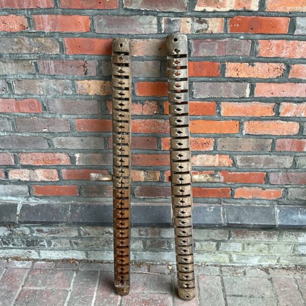 Antique Japanese rug loom parts with repeating raised sections.