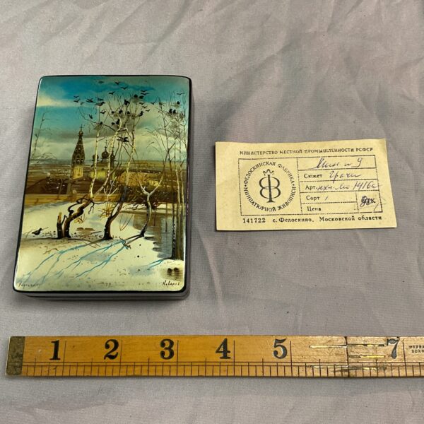 Vintage Russian lacquer box with a detailed winter landscape painting.
