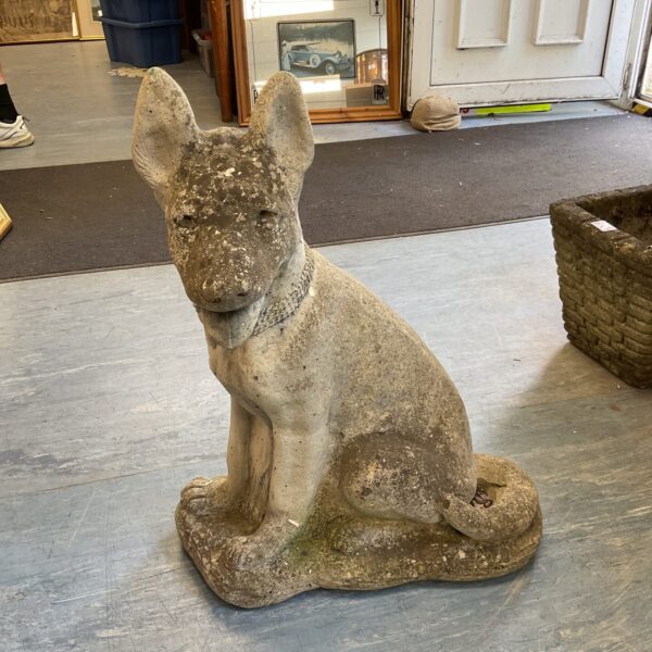 Large concrete garden dog statue with weathered patina.