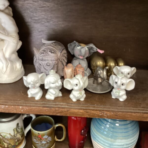 Close-up of a collection of vintage porcelain elephant figurines.